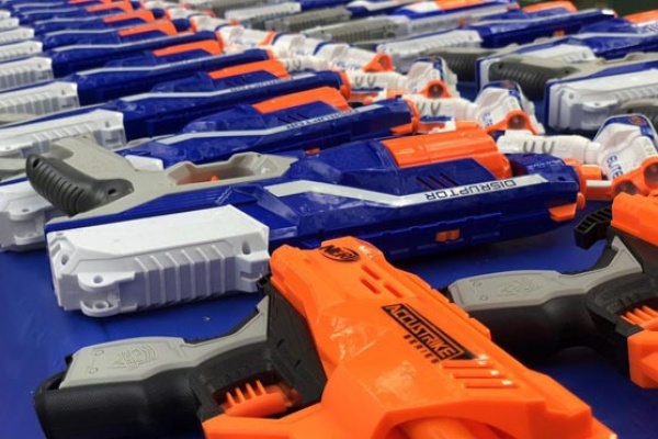 wide range of nerf guns on a blue table